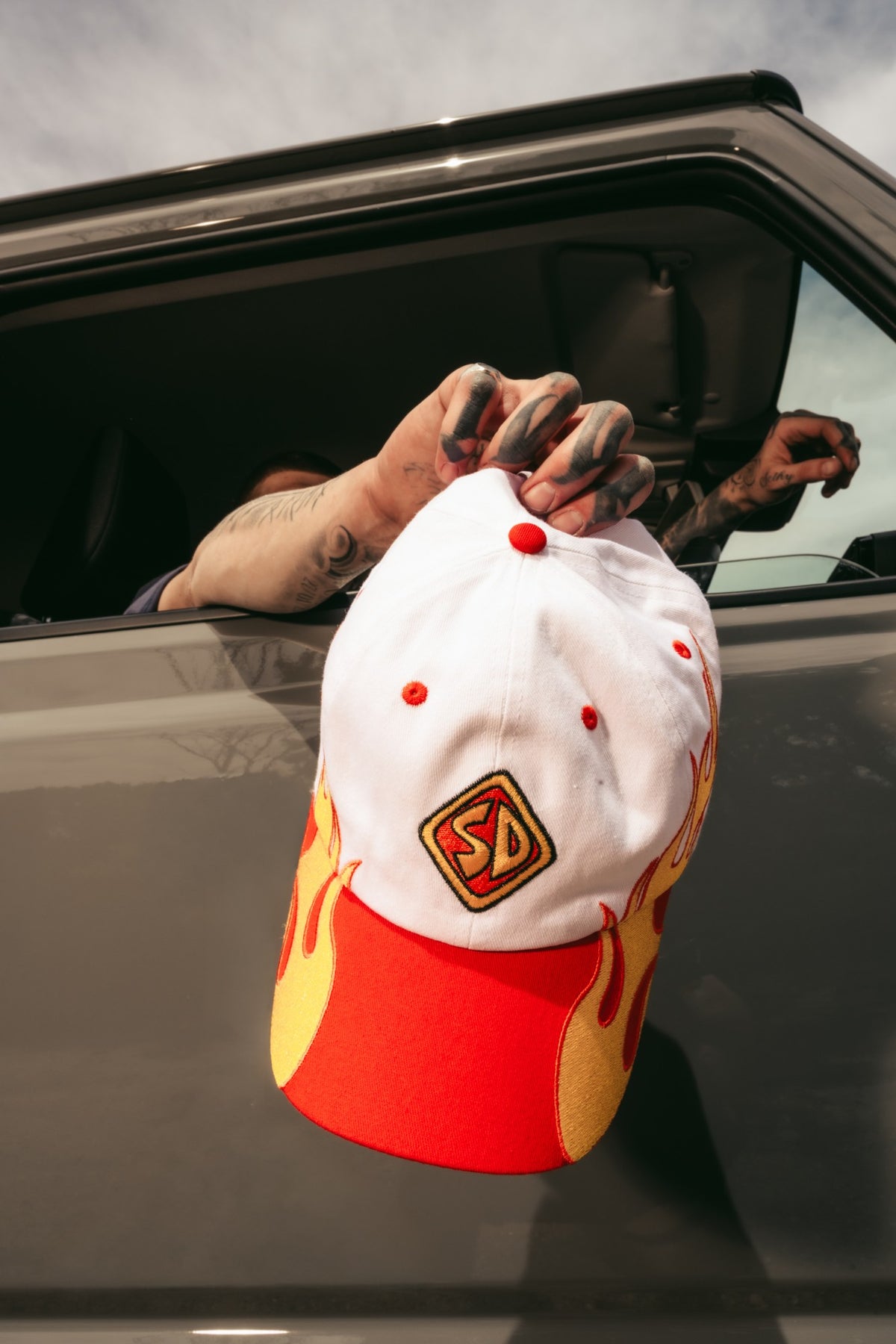 Scooby-Doo flame cap held out of a car window