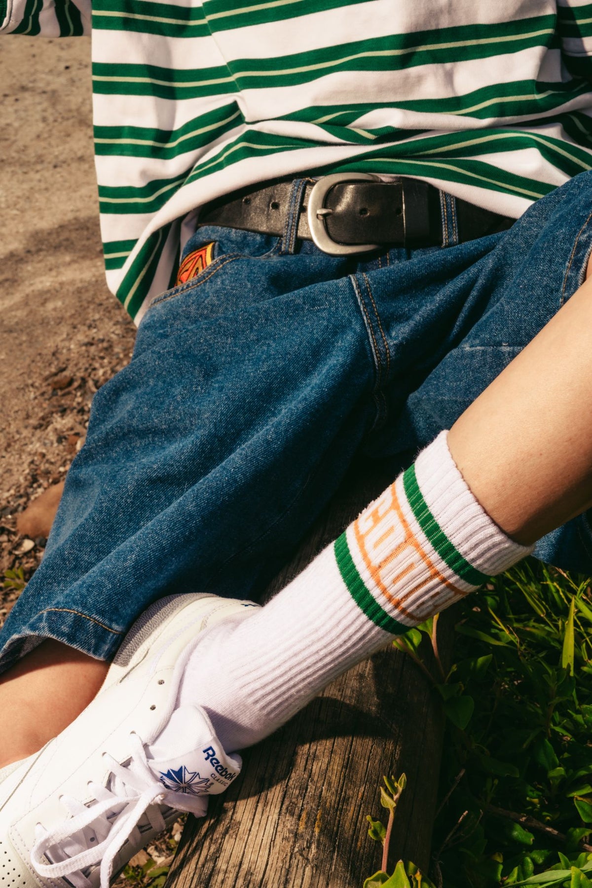 Close-up of the stripe tee, jorts and Scooby-Doo socks
